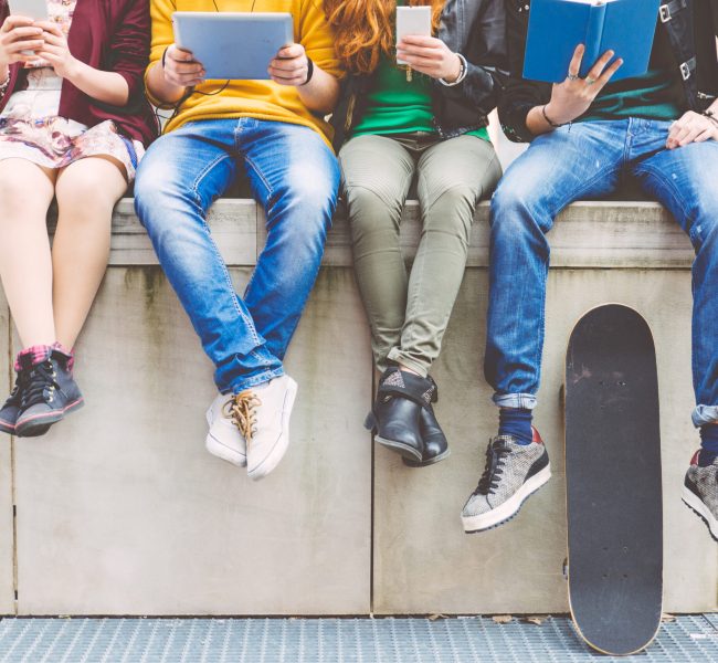 Group,Of,Teenagers,Making,Different,Activities,Sitting,In,An,Urban